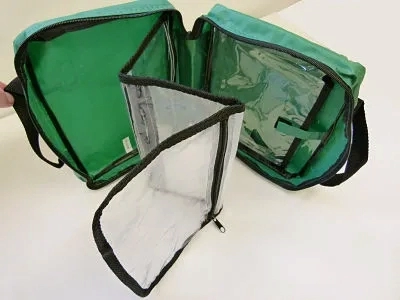 Green First Aid Bag With Handles 3 clear fold out compartments.